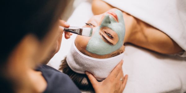 cosmetologist applying mask face client beauty salon 1