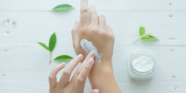 woman holds jar with cosmetic cream her hands