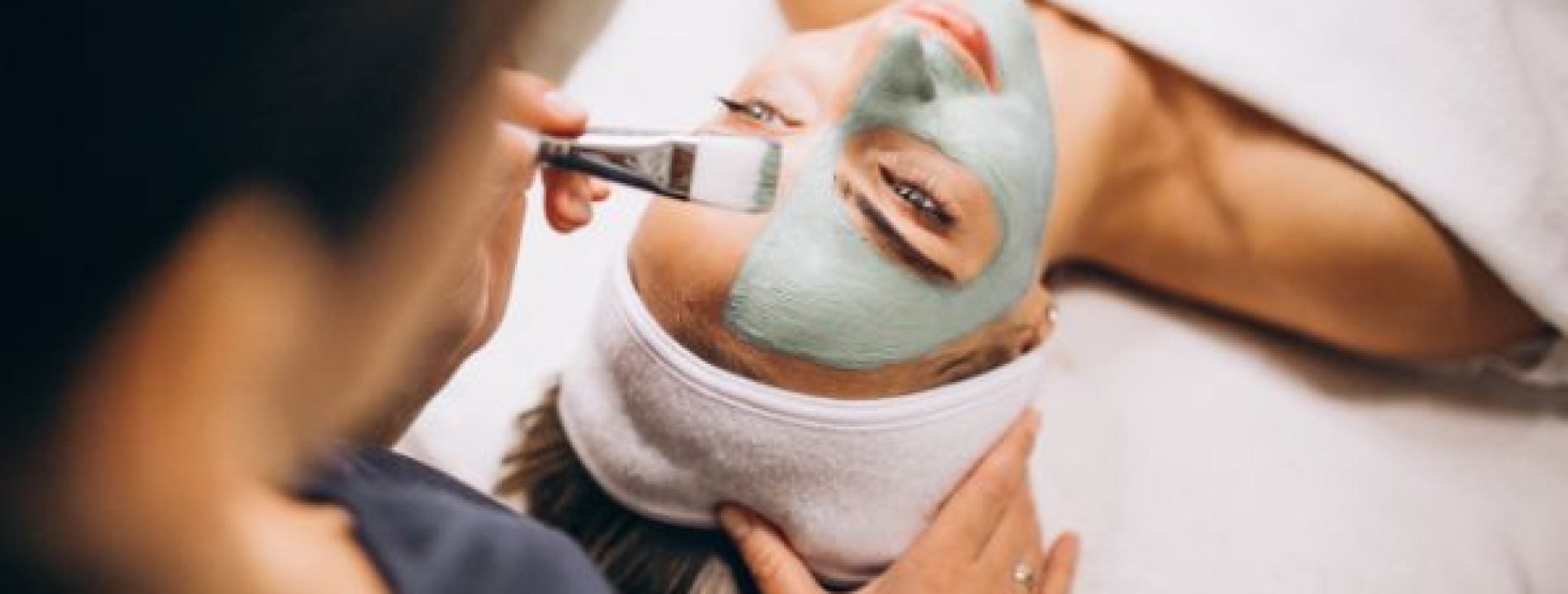 cosmetologist applying mask face client beauty salon 1